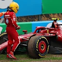 ZANDVOORT, NETHERLANDS - AUGUST 31: A marshal assists Lewis Hamilton of Great Britain and Scuderia Ferrari after a crash during the F1 Grand Prix of Netherlands at Circuit Zandvoort on August 31, 2025 in Zandvoort, Netherlands. (Photo by Andy Hone/LAT Images)