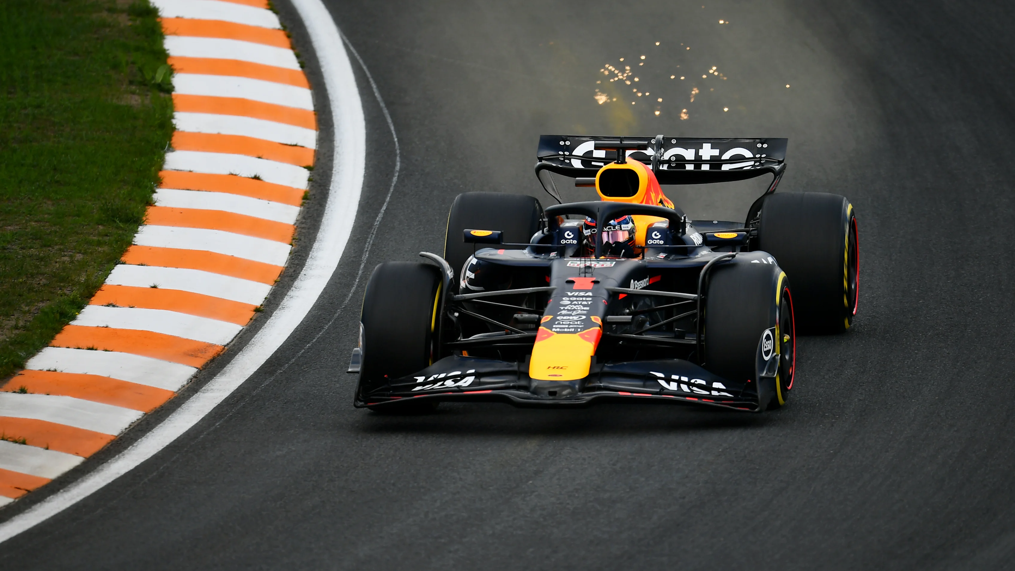 ZANDVOORT, NETHERLANDS - AUGUST 29: Sparks fly behind Max Verstappen of the Netherlands driving the (1) Oracle Red Bull Racing RB21 on track during practice ahead of the F1 Grand Prix of Netherlands at Circuit Zandvoort on August 29, 2025 in Zandvoort, Netherlands. (Photo by James Sutton/Getty Images)