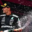 BAKU, AZERBAIJAN - SEPTEMBER 21: Second placed George Russell of Great Britain and Mercedes AMG Petronas F1 Team sprays Champagne on the podium during the F1 Grand Prix of Azerbaijan at Baku City Circuit on September 21, 2025 in Baku, Azerbaijan. (Photo by James Sutton - Formula 1/Formula 1 via Getty Images)