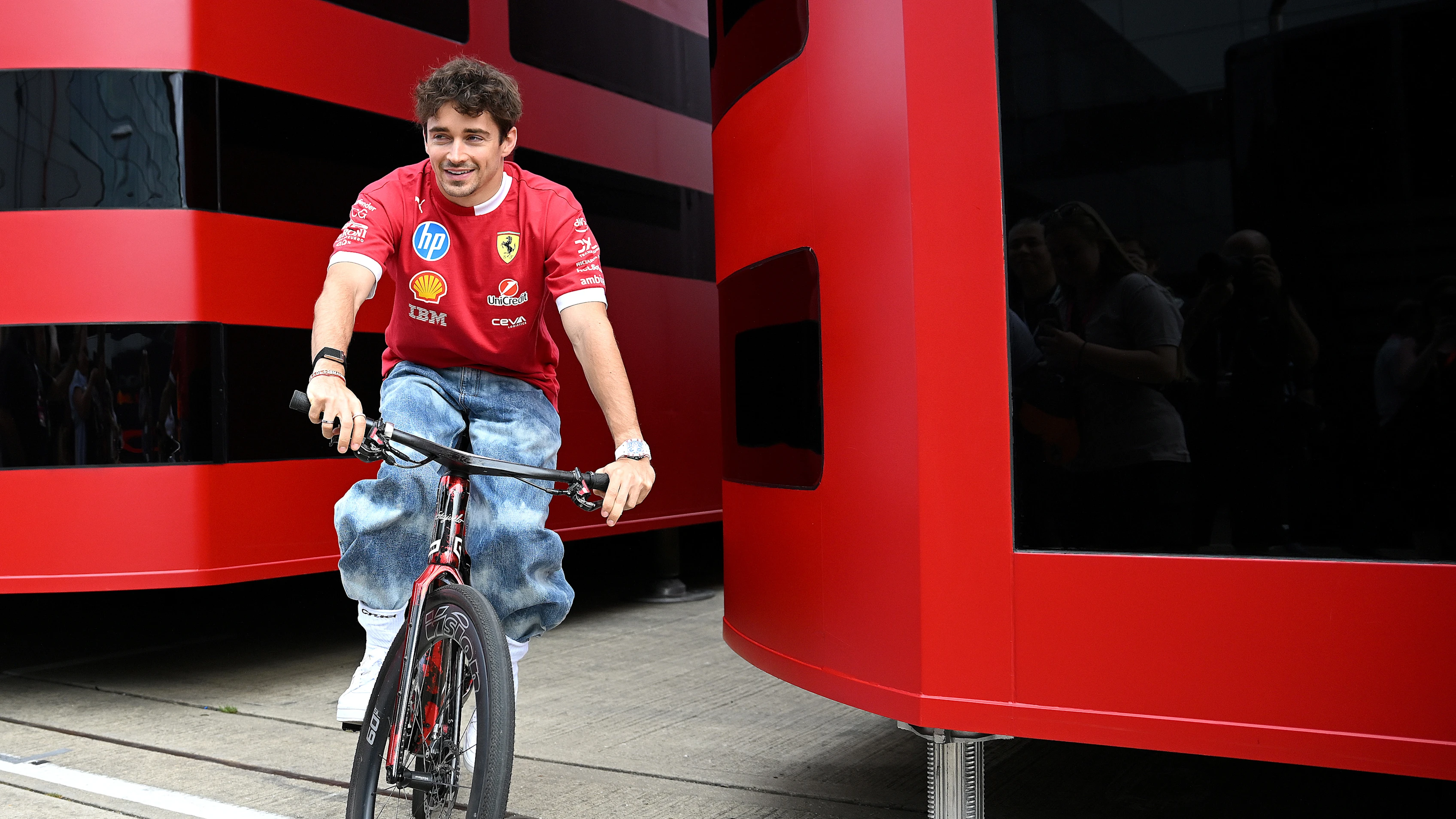 NORTHAMPTON, ENGLAND - JULY 03: Charles Leclerc of Monaco and Scuderia Ferrari on a bicycle in the