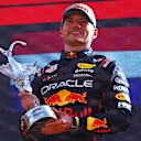 MONZA, ITALY - SEPTEMBER 07: Race winner Max Verstappen of the Netherlands and Oracle Red Bull Racing on the podium with the winners trophy during the F1 Grand Prix of Italy at Autodromo Nazionale Monza on September 07, 2025 in Monza, Italy. (Photo by Peter Fox/Getty Images)