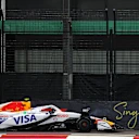 SINGAPORE, SINGAPORE - OCTOBER 03: Liam Lawson of New Zealand and Visa Cash App Racing Bulls stands by his damaged car after a crash during practice ahead of the F1 Grand Prix of Singapore at Marina Bay Street Circuit on October 03, 2025 in Singapore, Singapore. (Photo by Bryn Lennon/Getty Images)