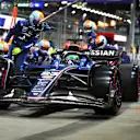 SINGAPORE, SINGAPORE - OCTOBER 05: Alexander Albon of Thailand driving the (23) Williams FW47 Mercedes makes a pitstop during the F1 Grand Prix of Singapore at Marina Bay Street Circuit on October 05, 2025 in Singapore, Singapore. (Photo by Bryn Lennon/Getty Images)
