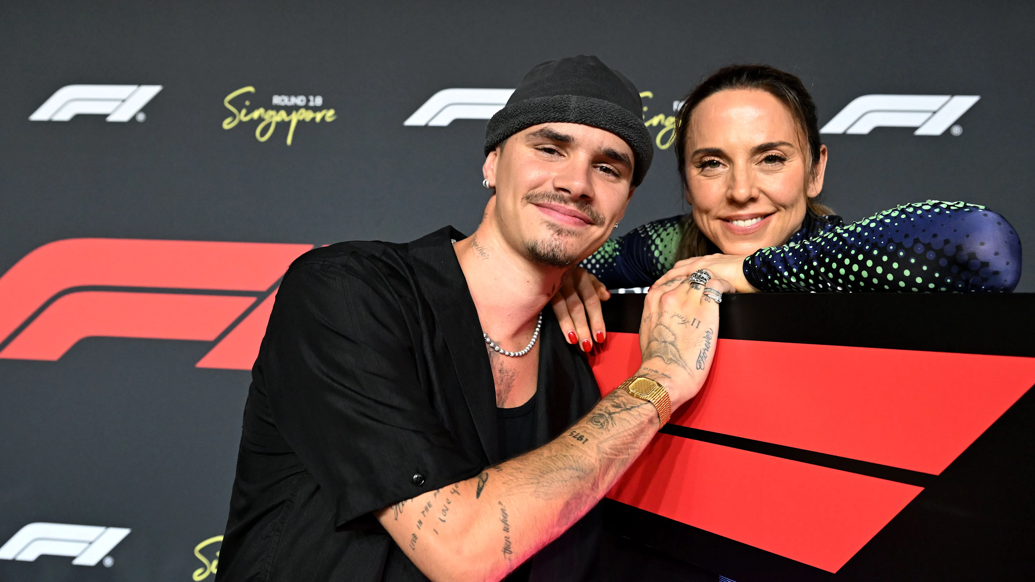 Mel C des Spice Girls est tombé sur Romeo Beckham devant le Grand Prix. BLAPS POUR PLUS D'IMAGES
