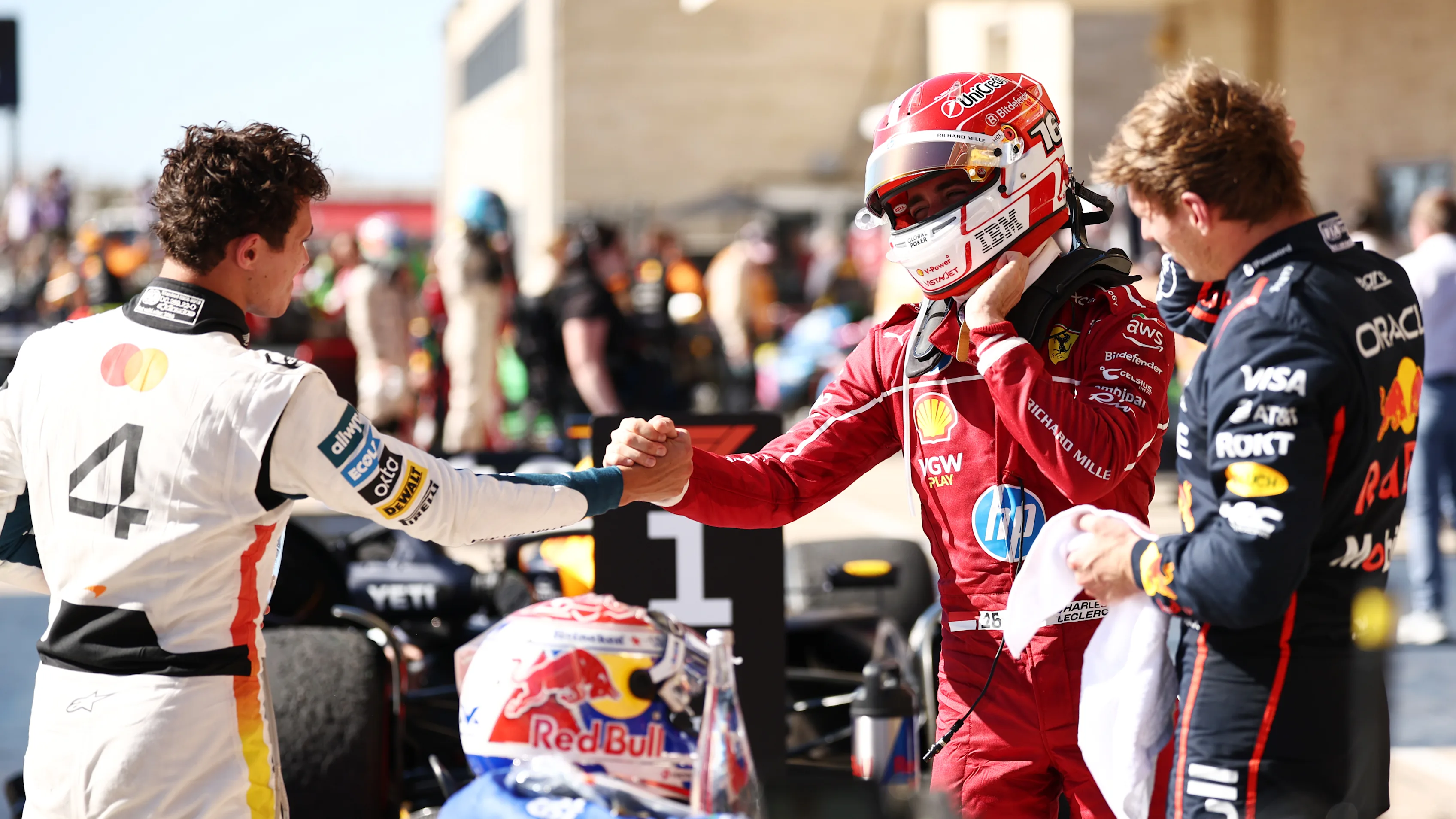 AUSTIN, TEXAS - OCTOBER 19: Race winner Max Verstappen of the Netherlands and Oracle Red Bull Racing Second placed Lando Norris of Great Britain and McLaren and Third placed Charles Leclerc of Monaco and Scuderia Ferrari talk in parc ferme during the F1 Grand Prix of United States at Circuit of The Americas on October 19, 2025 in Austin, Texas. (Photo by Jared C. Tilton/Getty Images)