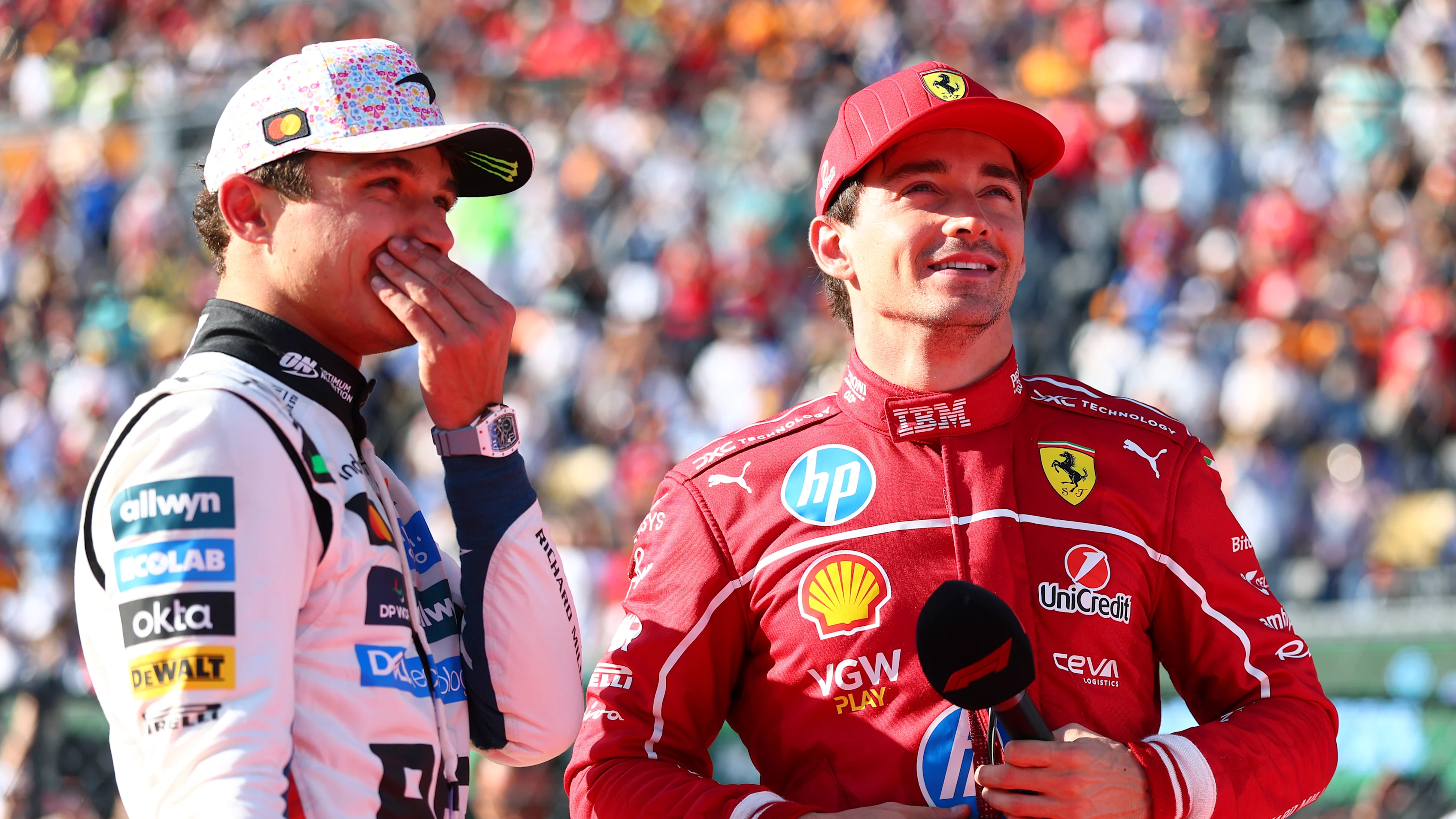 MEXICO CITY, MEXICO - OCTOBER 26: Race winner Lando Norris of Great Britain and McLaren and Second placed Charles Leclerc of Monaco and Scuderia Ferrari talk in parc ferme during the F1 Grand Prix of Mexico at Autodromo Hermanos Rodriguez on October 26, 2025 in Mexico City, Mexico. (Photo by Bryn Lennon - Formula 1/Formula 1 via Getty Images)