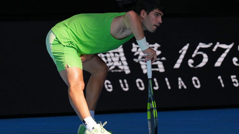 Carlos Alcaraz of Spain stretches during his semifinal match against Alexander Zverev of Germany at the Australian Open tennis championship 